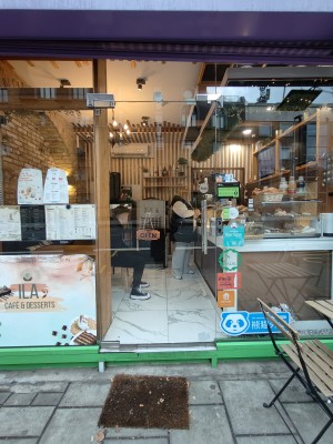 Facing glass door. Push silver metal handle on right to open.