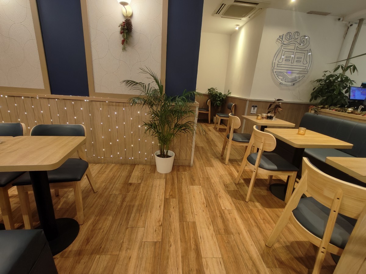 From end of half booths facing straight. Half booths on both sides. Path ahead to bathroom on back left.