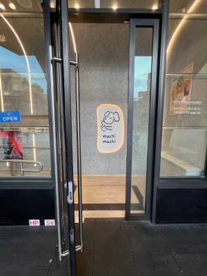 Glass door with grey metal frame. Pull silver handle from right.