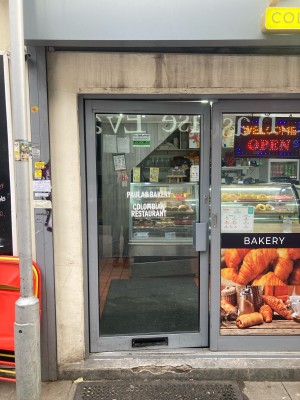 Glass door with grey frame ahead. Push to open via handle on right.