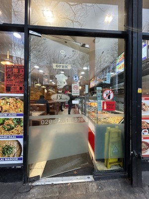 Glass door ahead. Push silver handle on right to open.