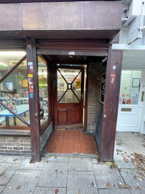 From street facing venue. Shutter ahead before door as open archway.