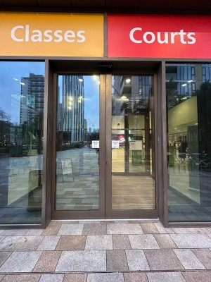 First set of glass doors with grey frame. Doors slide open outwards to open.