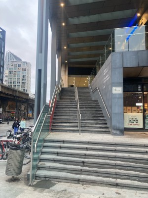From side road, facing venue. Staircase ahead. Handrail along left.