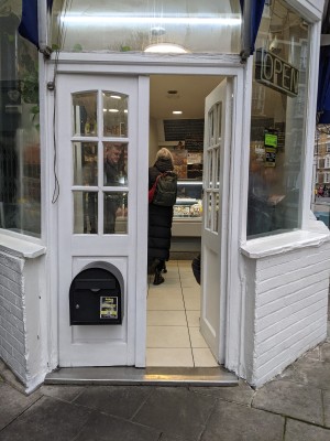 White wooden doors. Push from centre to open.