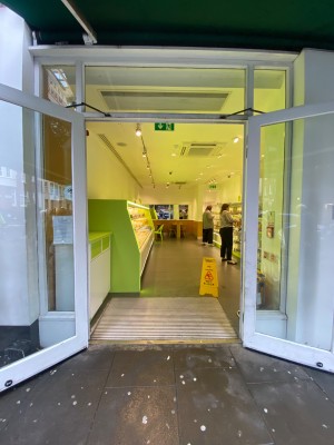 Double glass door, with white doorframe. Black handles at centre of door. Pull to open.