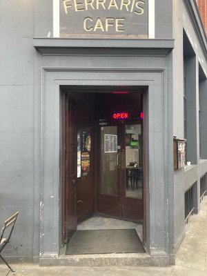 Brown wooden doors ahead. Push doors to open via handles in center.