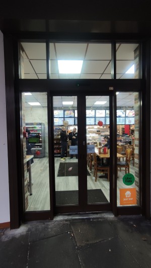 Automatic glass doors with brown frames. Approach doors for entry.