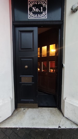 Black doors ahead. Push in centre to open.