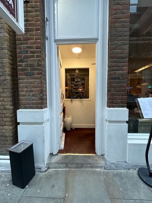 White and glass panelled door. Push metal handle on right to open.