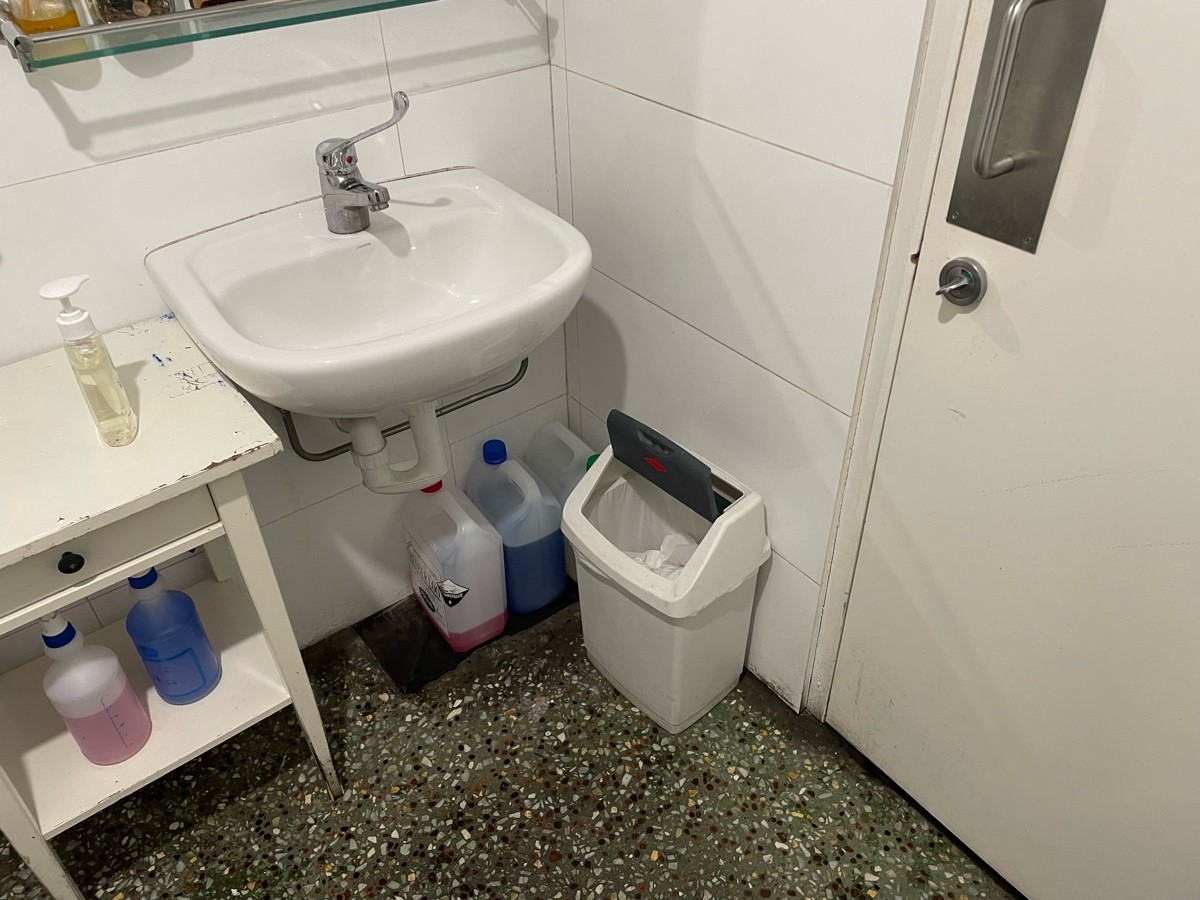 Inside under sink cluttered store as well