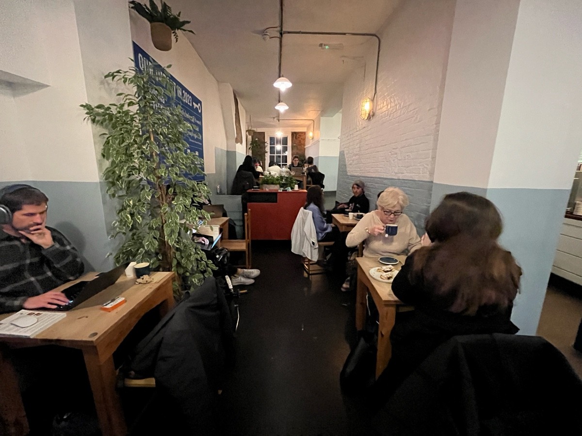 From after divider facing right. Tables and chairs along left and right ahead.