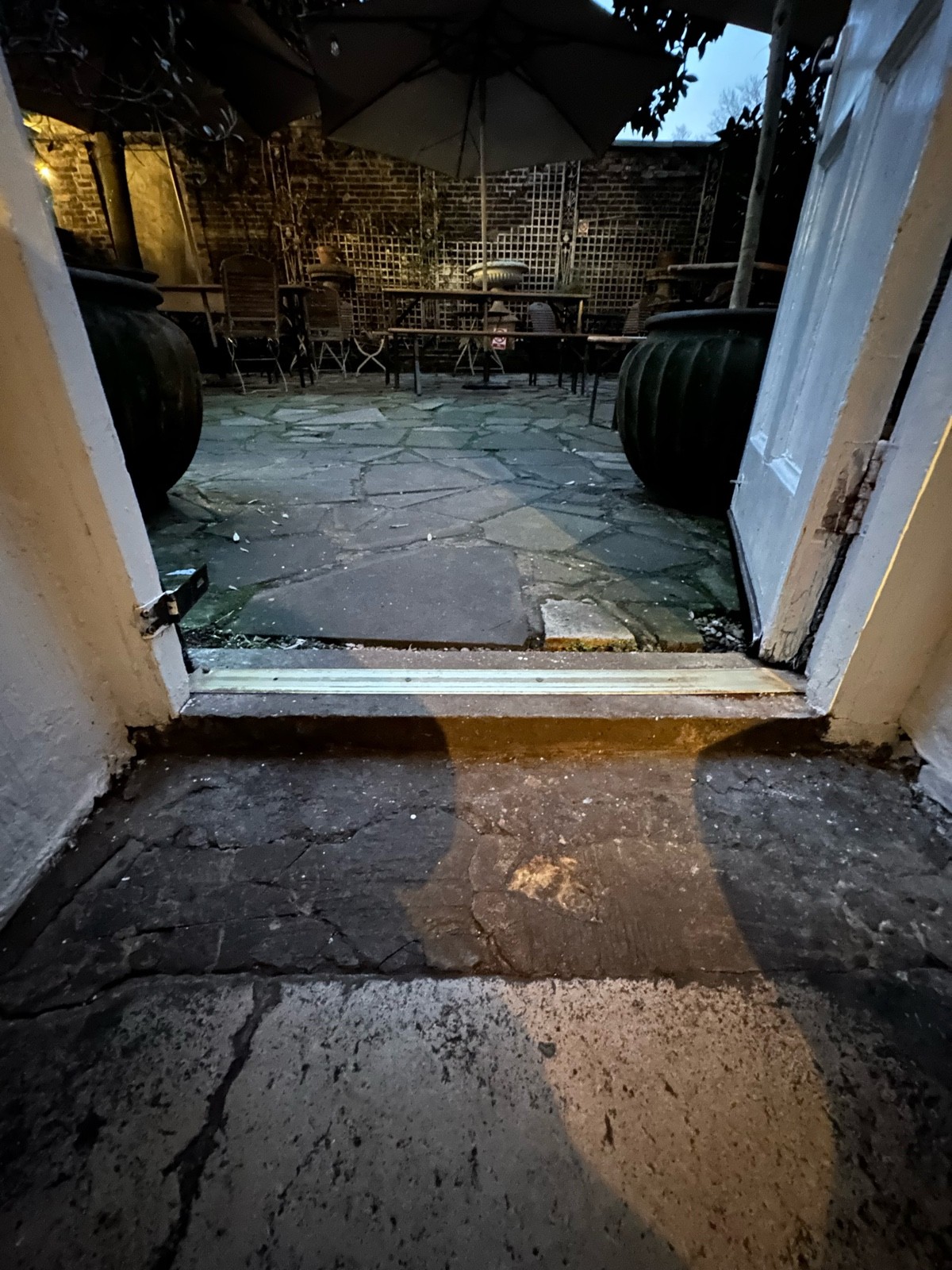 Step up at foot of door.