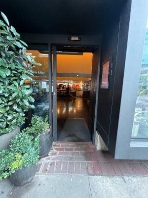 Glass door with grey metal frame. Door slides open to left.