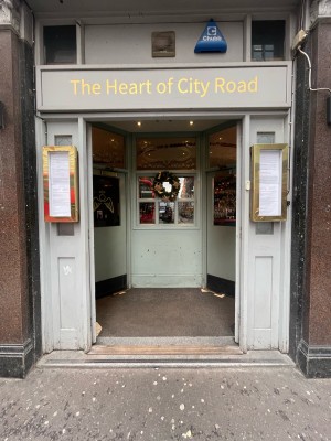 Glass and wooden doors ahead. Push gold metal handles from centre to open.