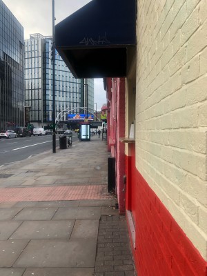 From pavement facing straight. Venue ahead on right.