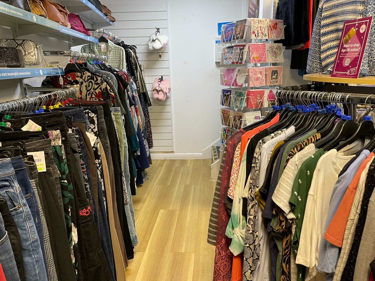 This photo is the path that leads to the rear of the shop floor, with a rack to your right and rails along the wall to your left