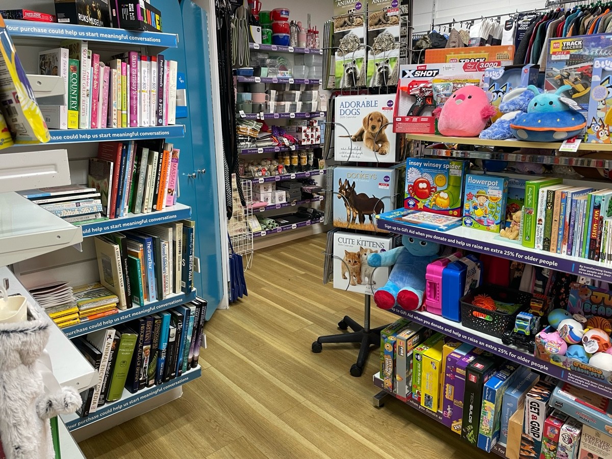 This photo is from the door to the second room, facing left. On your left there is shelves of books and to the right is a rack of kids toys.