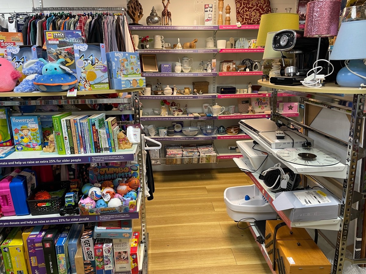 This photo is straight ahead from the door to the side room. To the left is kids toys, to the right is a rack of bric-a-brac, ahead is a wall of brica