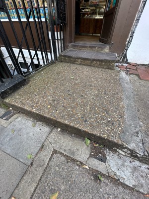 1 step up from pavement to area before door.