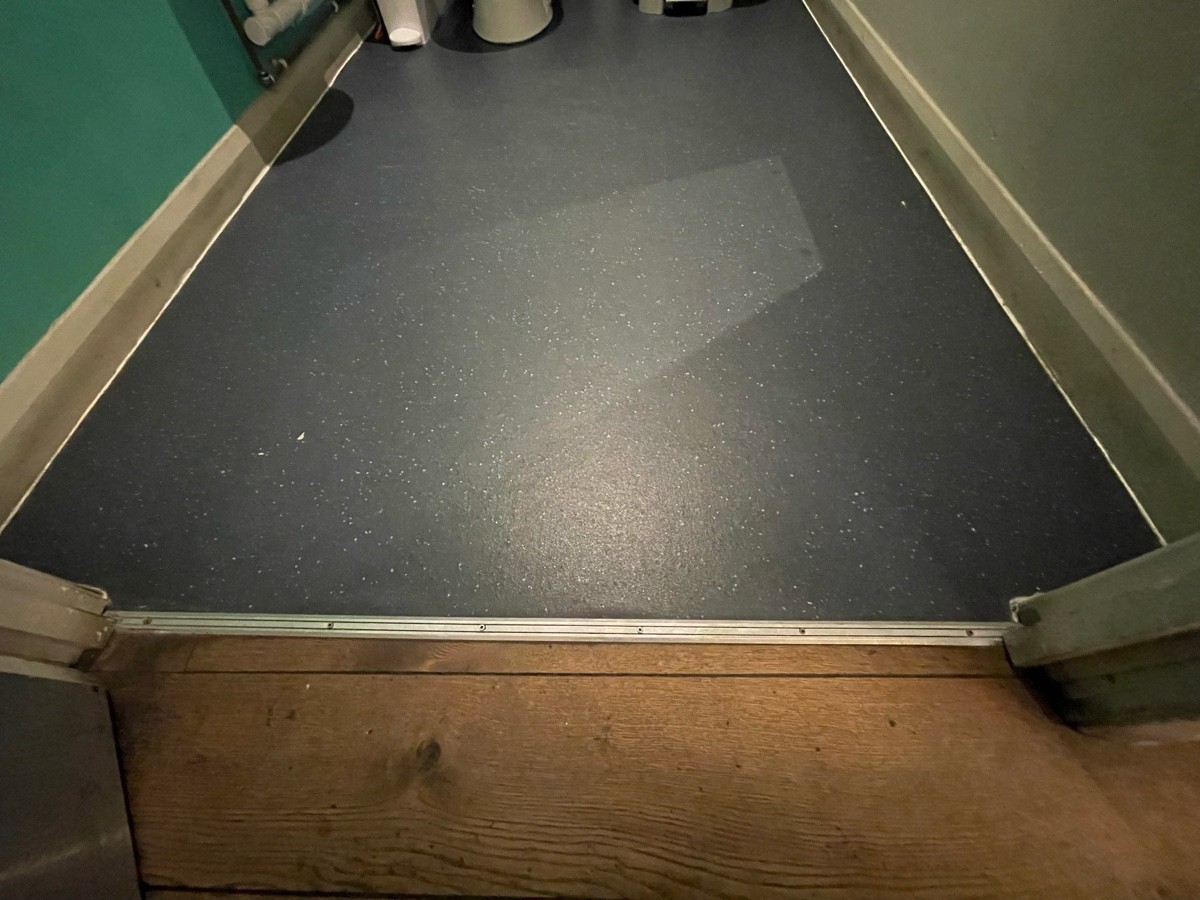 Metal bump at foot of door.