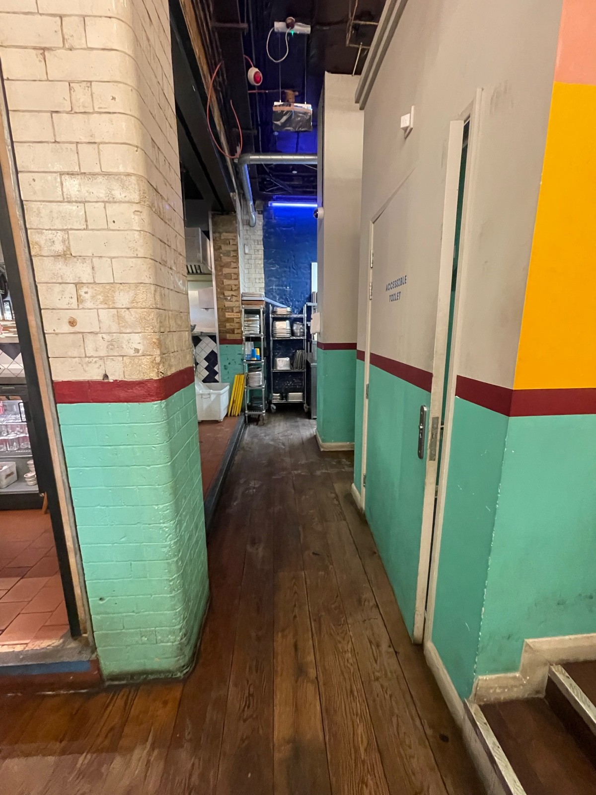 From right end of main area facing straight. Bathroom door ahead to right.