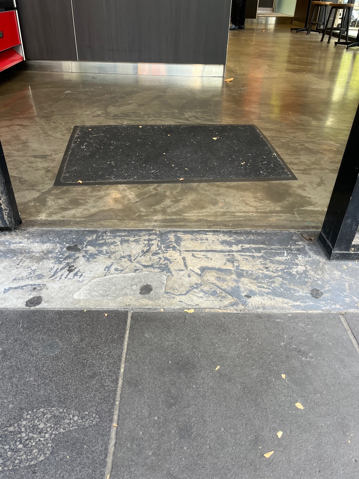 Small bump at foot of door followed by doormat.