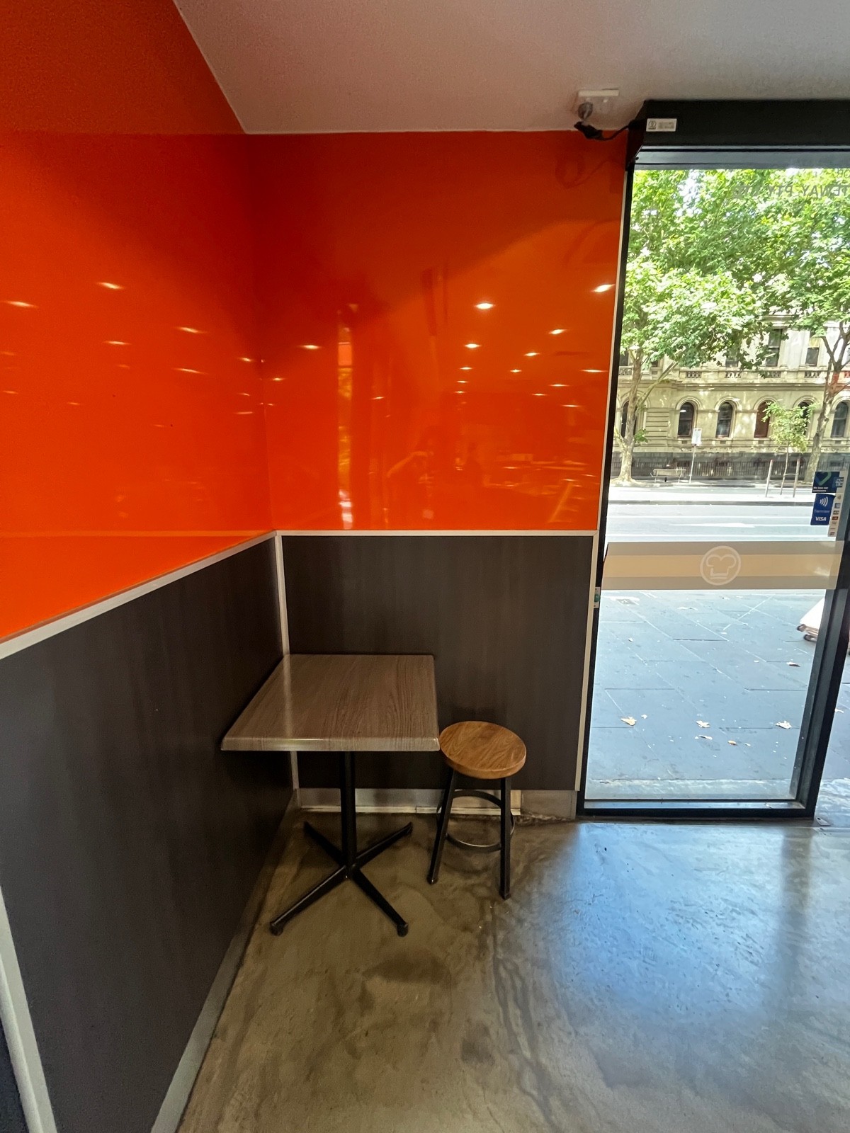 From entrance facing left. Table with backless stool ahead.
