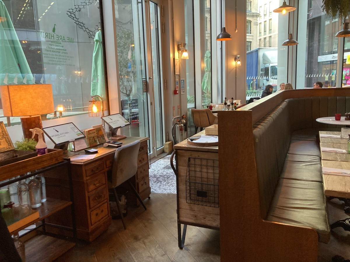 From end of half booth, facing right. Alternative welcome desk on left, door behind. Service desk on right.