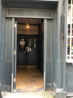 Wooden teal door. Push on right to open.
