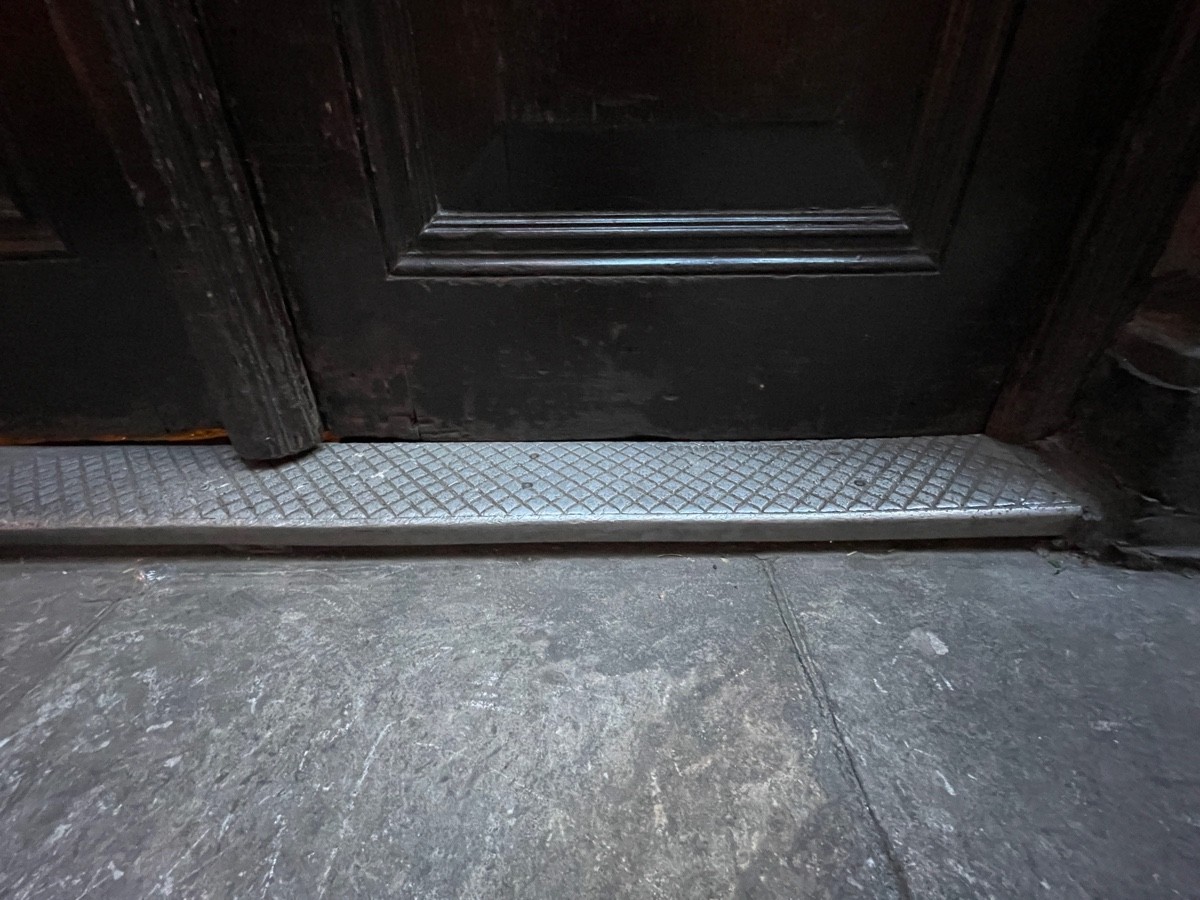 One metal step up at threshold of door.