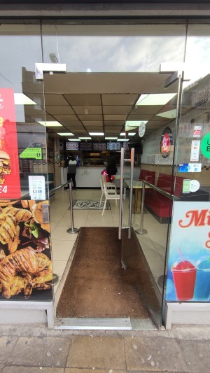 Glass door ahead. Push metal handle on left to open.