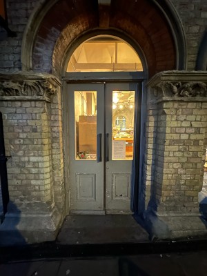 Grey and glass panelled doors. Push handles in centre to open.