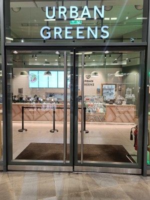 Glass doors with silver, metal frame. Push silver, metal handle in middle to open.
