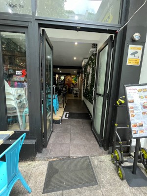 Glass double doors with black metal frame. Push from middle.