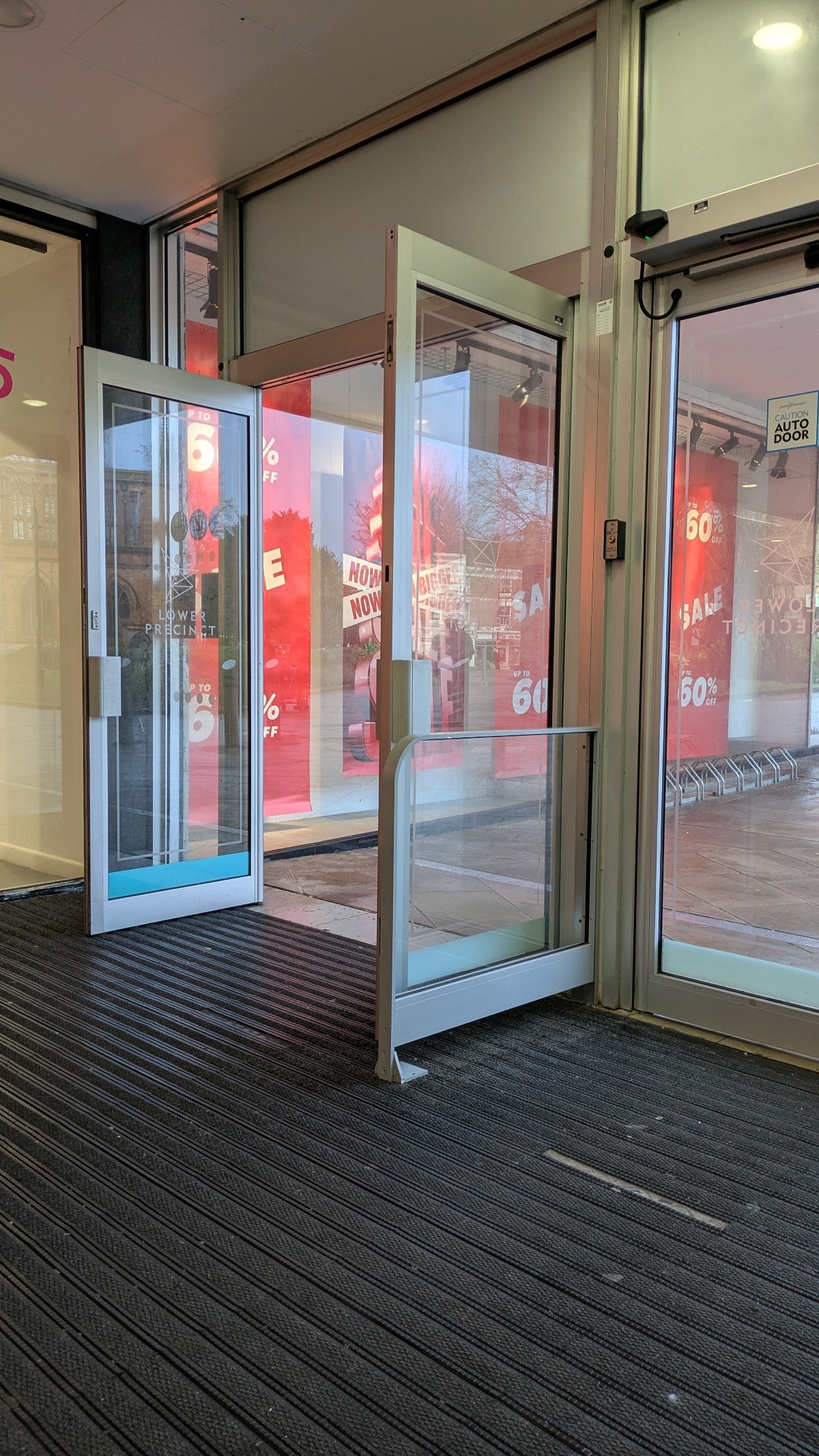 Back entrance to the centre onto the street at the rear of the building. Level access on hard carpet leading out via auto-open doors.