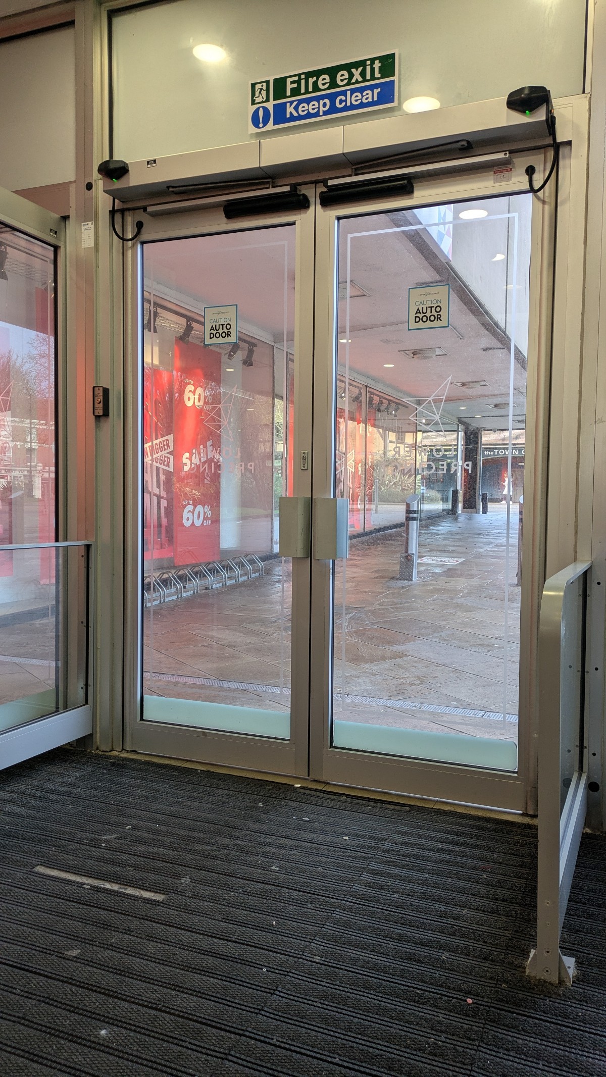 The reflective and transparent glass doors at each entrance other than the open ramp at the front of the centre. There is very low contrast throughout