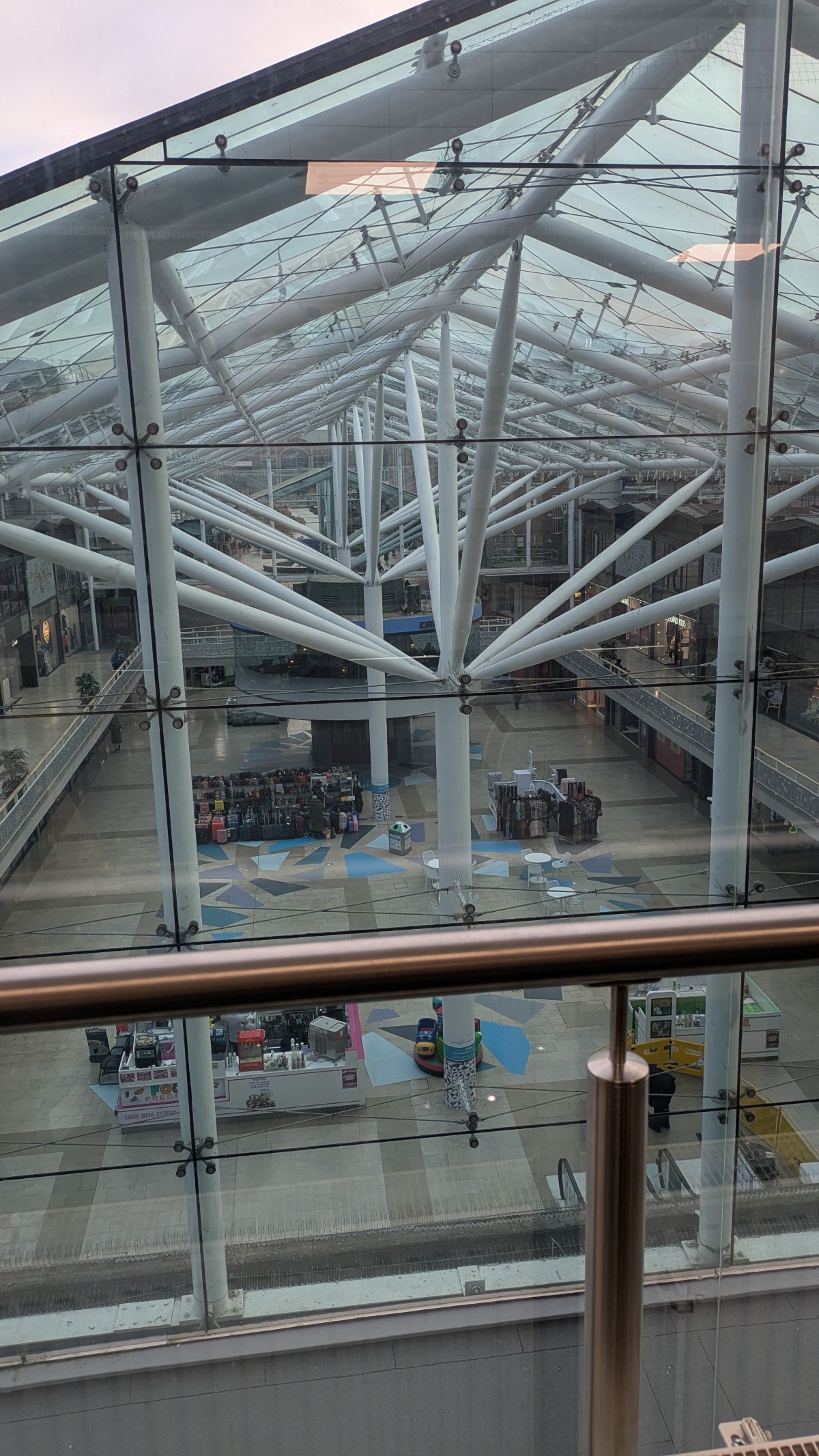 A birds eye view of the main centre mall, through another glass panel (window of management suite). This shows the floor and surrounding pathways.