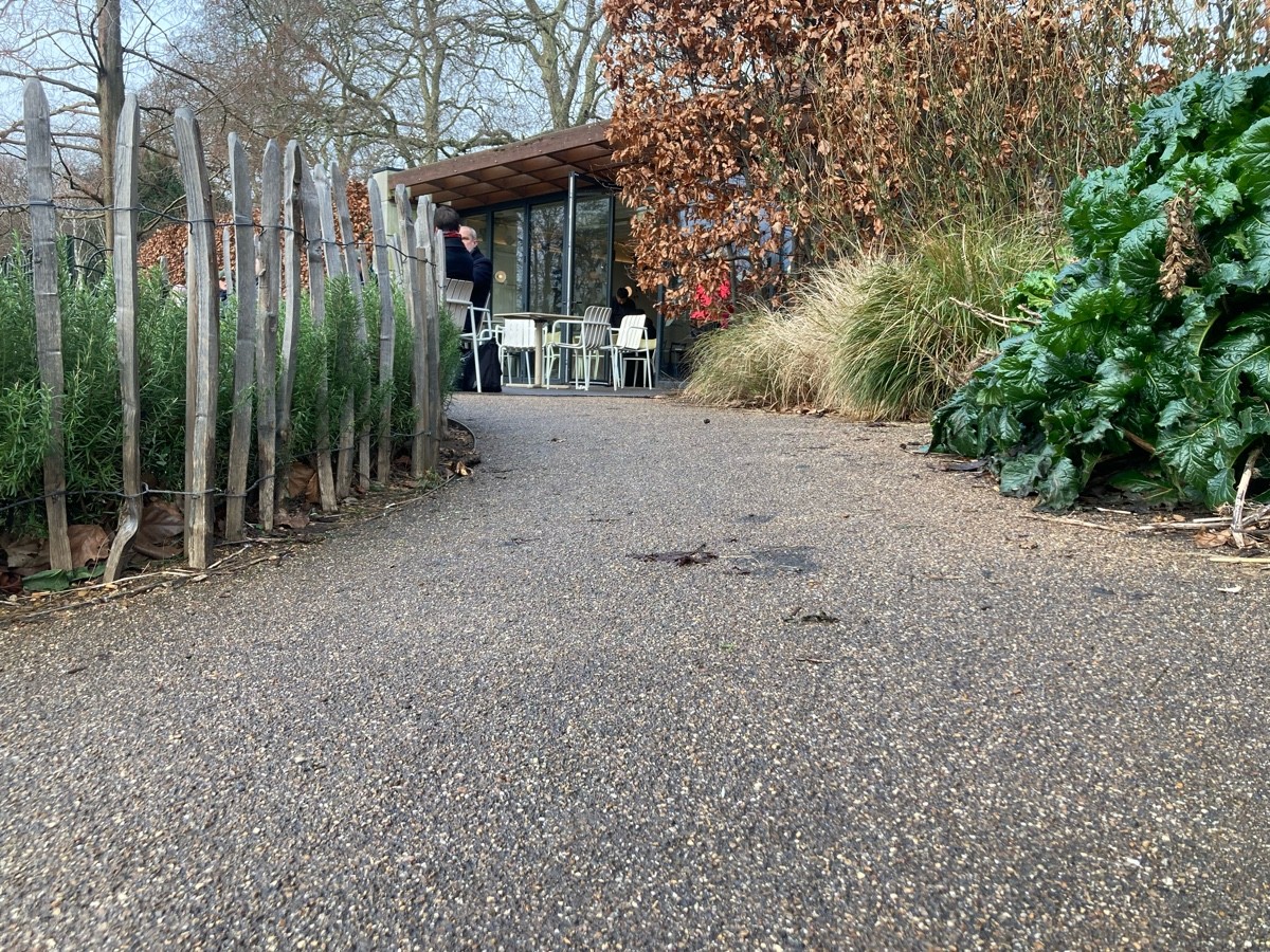 Path to seating area slopes upwards and curves left.