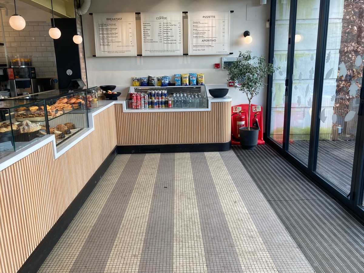 From entrance, facing right. Product display on back and along left.