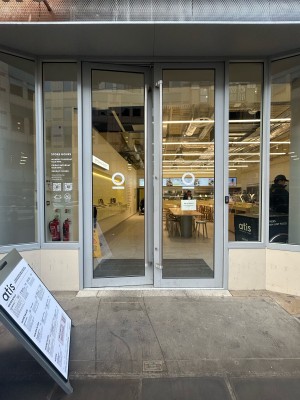 Glass doors with silver frame ahead. Push silver handles in centre to open.