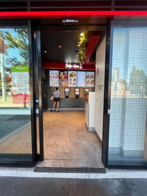 Glass door with black metal frame. Door slides open to left.