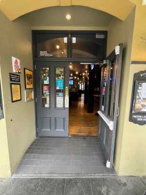 Grey wooden double doors with glass panels. Pull silver handles from middle.