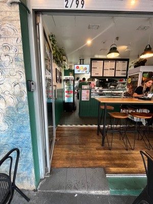 Glass door with grey metal frame. Push from right.