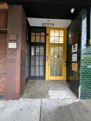 Path to entrance. Door on left wall ahead.