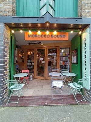 From street, facing venue. Seating on both sides. Path in middle to doorway at back.