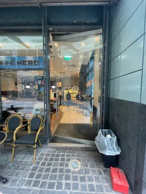 Glass door ahead. Push silver metal handle on left to open.