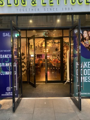 Glass doors with black frame ahead. Pull doors to open from centre.