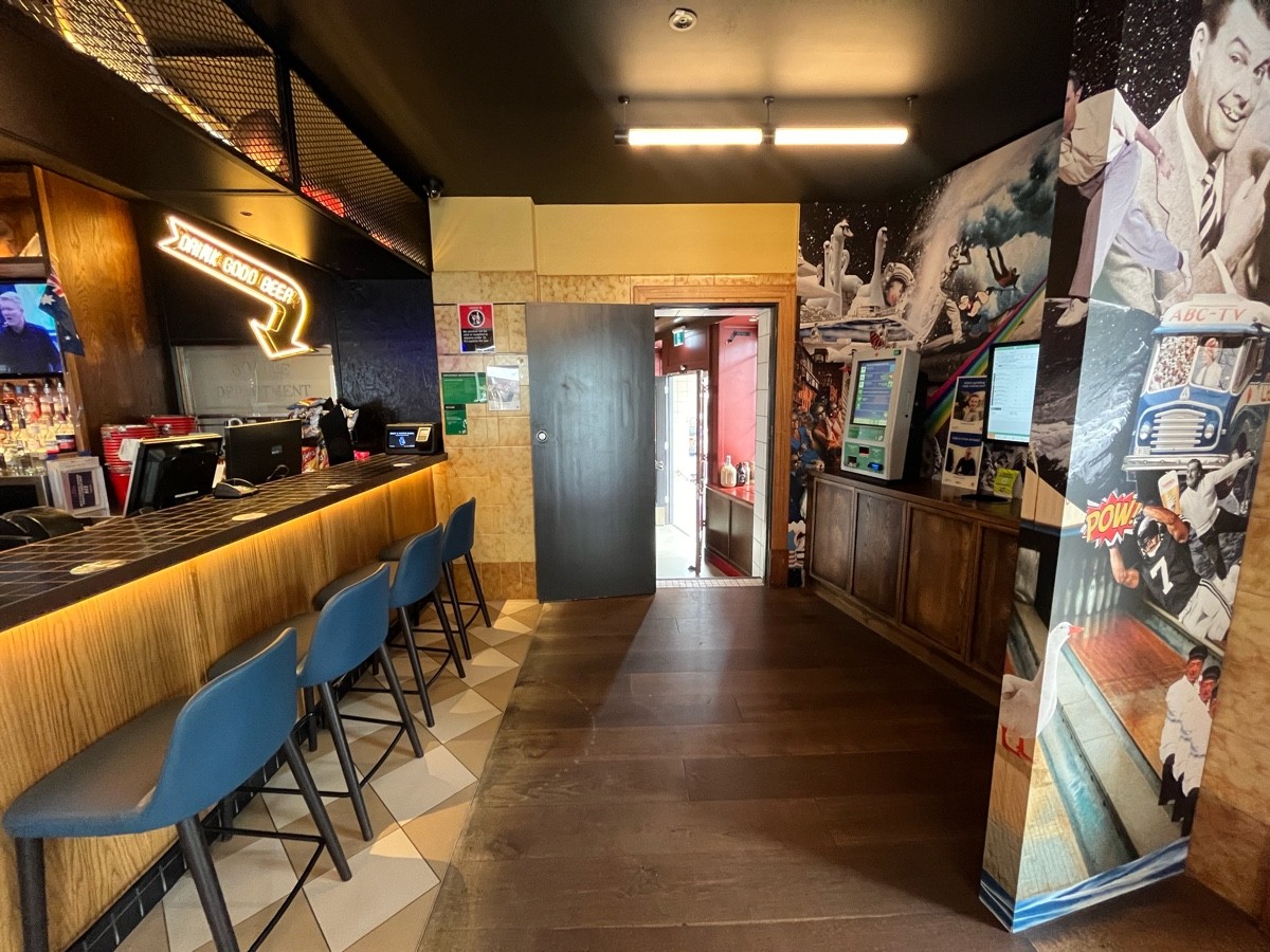 From entrance facing right. Bar with backed stools along left.