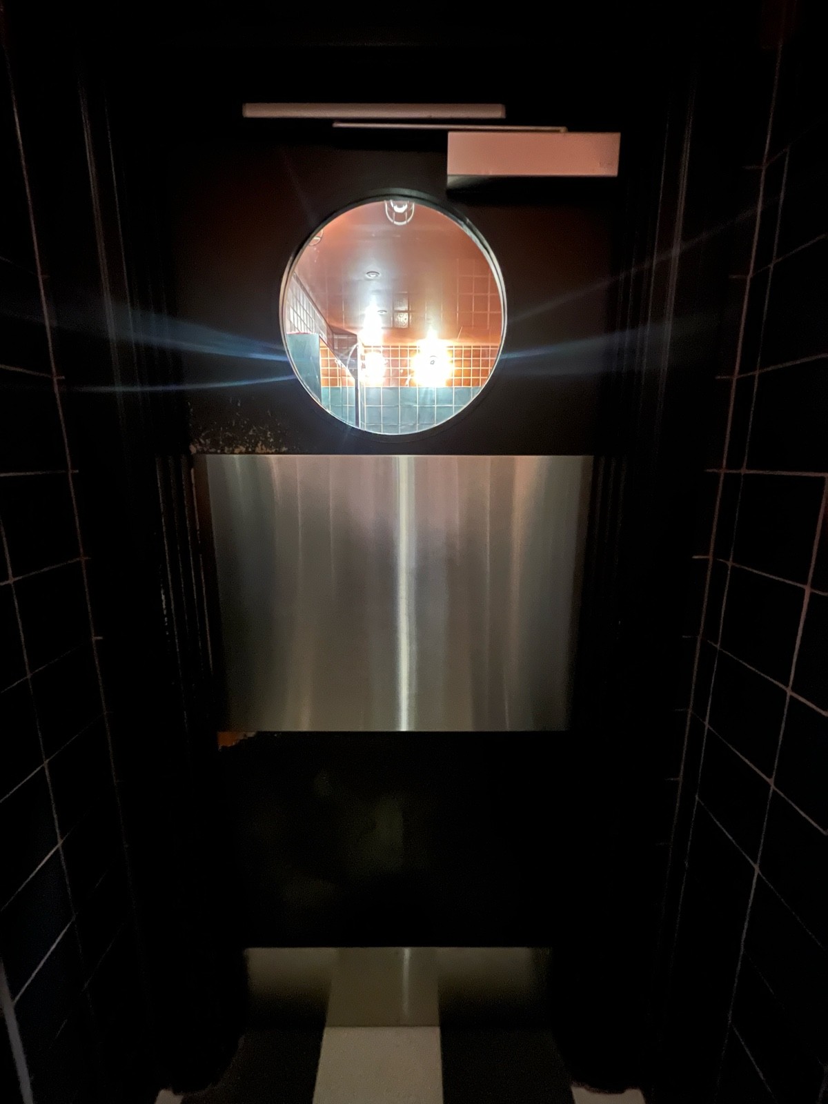 From preceding door facing left. Brown wooden door ahead. Push from left.